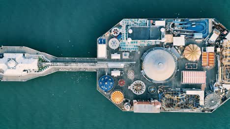 cinematic bird’s-eye footage of brighton palace pier. the iconic seaside attraction meets the shimmering sea, creating a dynamic, cinematic coastal scene. perfect for travel and nature visuals.