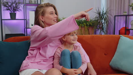 Young-woman-mother-having-trustworthy-conversation,-talking-with-daughter-child-kid-at-home-sofa