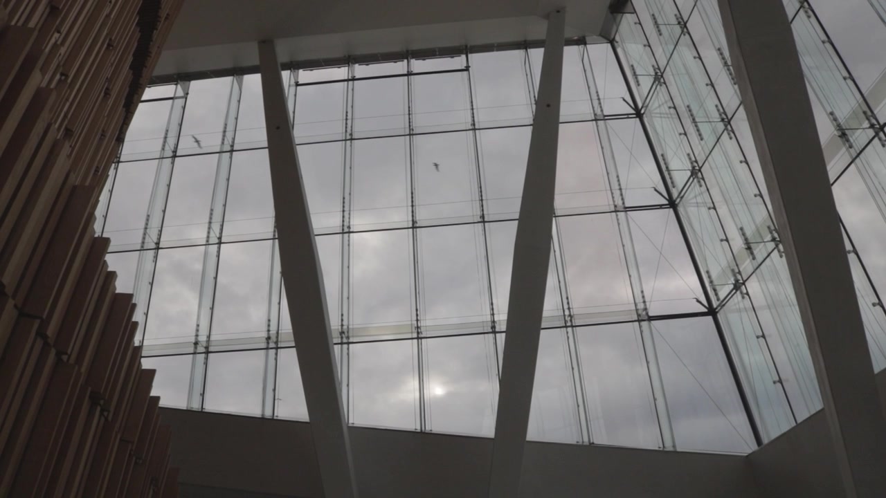 Interior view of the glass facade and columns inside Oslo Opera House