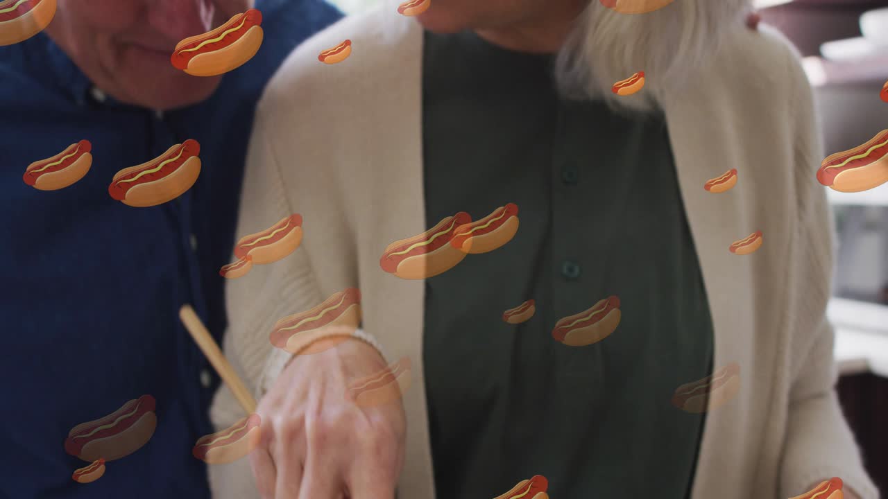animación de iconos de perritos calientes con una pareja caucásica de alto nivel cocinando