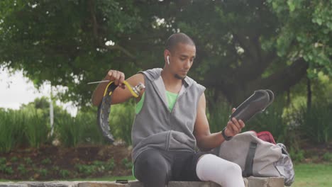 Front-view-man-readjusting-his-prosthetic-leg