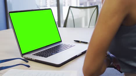 Video-of-african-american-woman-working-on-laptop-with-copy-space-on-screen