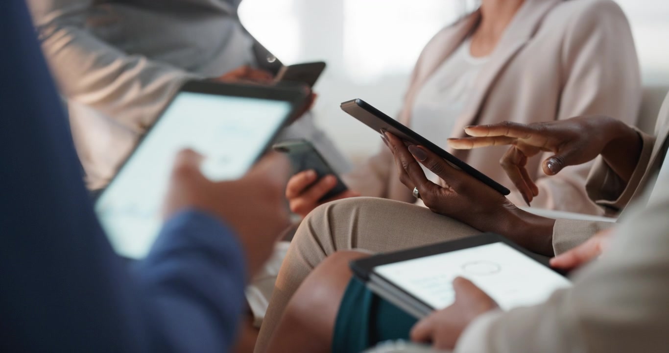 Business Team Using Digital Tablets and Smartphones in Office Meeting