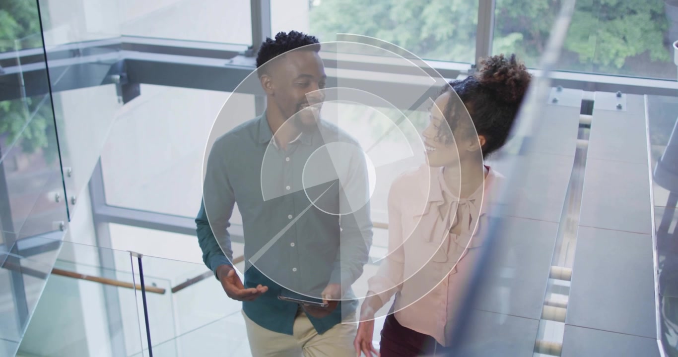 Coworkers entering climbing glass stairs while glancing tablet and animated business charts forming