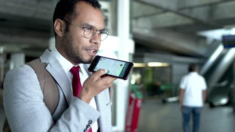 businessman with backpack talking by smartphone