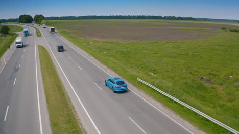 all-electric car drive on road. new audi rides on the road near the field