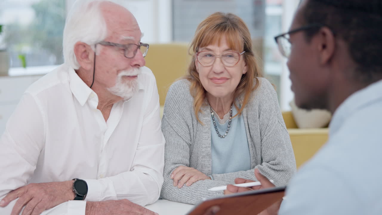 Elderly couple talking with a male accountant by