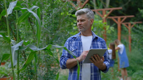 farmer using a tablet in a cornfield