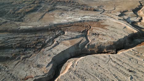 aerial view of the cracked landscape on a sunny day, drone flying forward - scenic view of the landscape