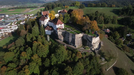 fantastic aerial shot in orbit on a sunny day of lenzburg castle and where the swiss flag can be seen