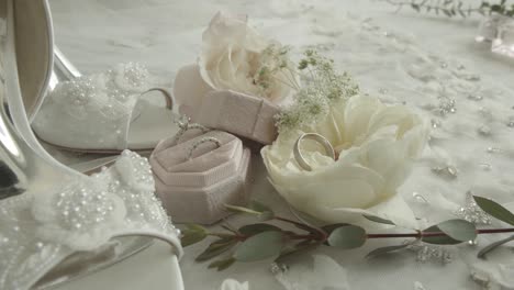 newly married couple's wedding rings with decorations and flowers