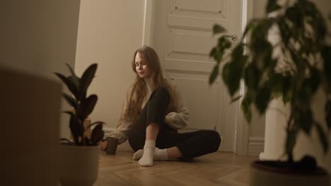 young woman sitting on the floor at home