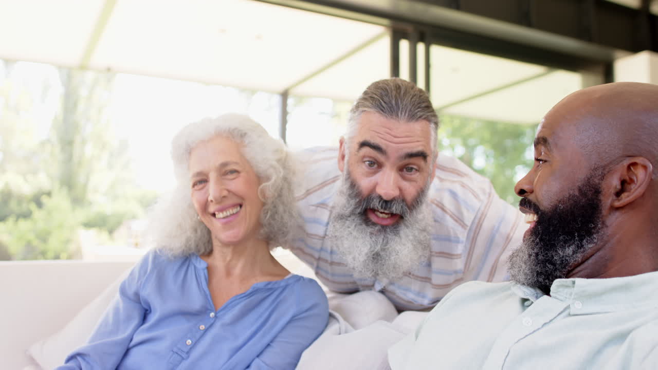 Senior friends laughing and enjoying time together on sunny day