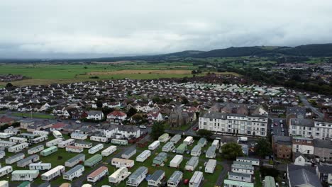 Static-caravan-trailer-beachfront-staycation-holiday-home-campground-resort-countryside-aerial-view-right-panning-shot