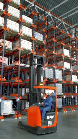 forklift in a warehouse with high storage rack