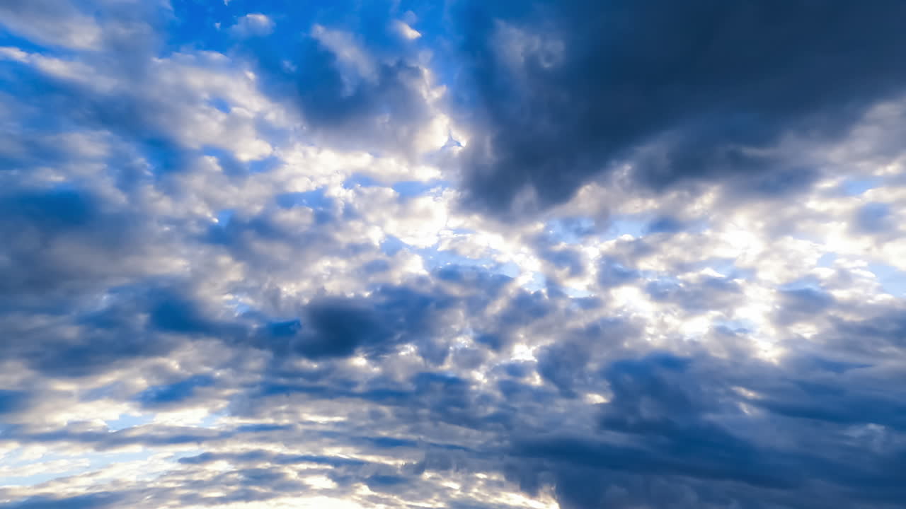 Dark cloudscape spreading by the horizon. Formation of rainy cloudscape in the sky. Low angle view. Timelapse.