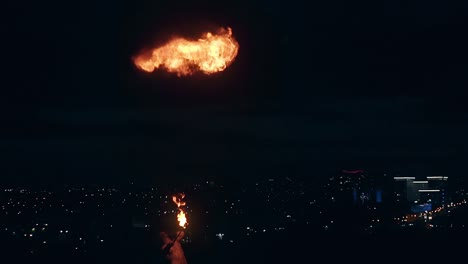 young blond male does tricks with fire male breaths out large stream of fire making fireball slow motion shot