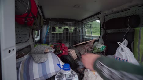 rear trunk of a camper van filled with packed stuff for camping