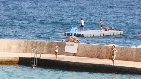 people swimming and relaxing by the sea