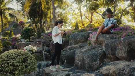 friends taking pictures in a tropical garden
