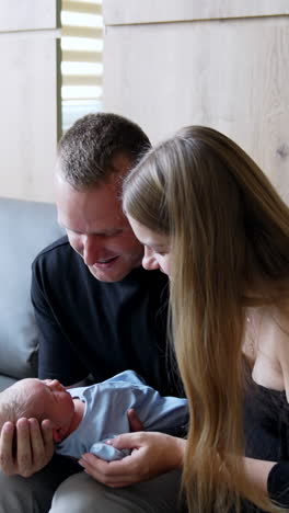 parenthood healthcare happy family. newborn baby with young family holding. vertical video