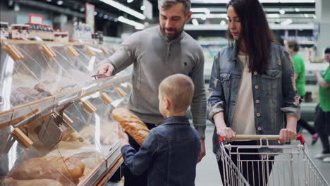 family shopping for bread at grocery store