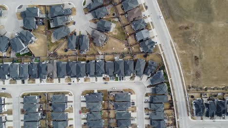 Aerial-view-of-a-modern-suburban-community-in-Calgary,-Canada,-in-spring-after-the-snow-melt