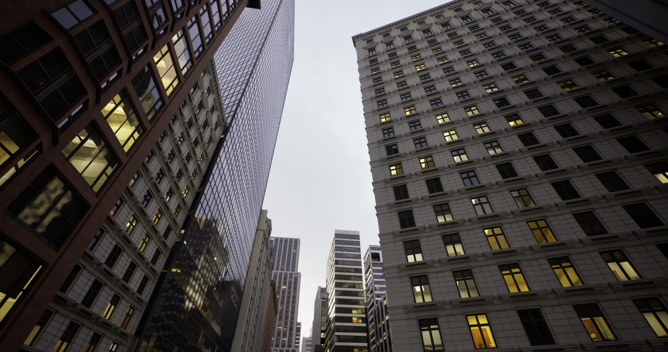Darkness enhances luminous grid patterns on towering glass buildings