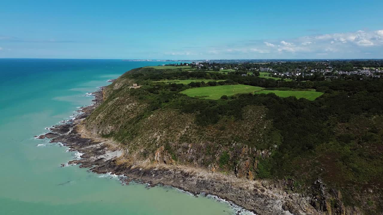 Drone footage captures the majestic cliffs of Carolles in Normandy, with sweeping views of the coastline and the iconic Cabane Vauban perched above the sea