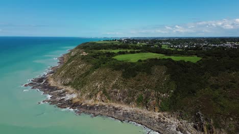 drone footage captures the majestic cliffs of carolles in normandy, with sweeping views of the coastline and the iconic cabane vauban perched above the sea