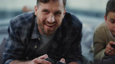 man and boy holding gamepads