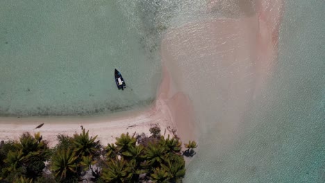 Beautiful-Aerial-drone-shot-of-an-island-in-a-blue-lagoon-of-the-atoll-of-Fakarava,-French-Polynesia,-south-pacific