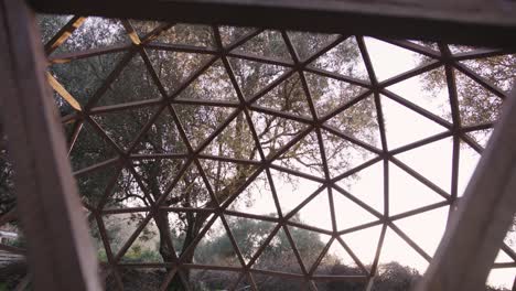 Mid-shot-of-wooden-hexagonal-geodome-structure-outdoors