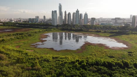 daytime aerial panoramic view of the wetlands of the buenos aires ecological reserve with the city buildings on the horizon