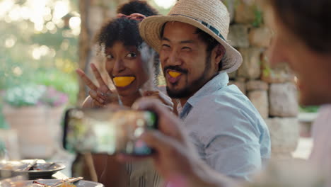 funny couple eating oranges posing for photo making faces having fun with friends laughing enjoying summer reunion outdoors happy tourist people on vacation 4k