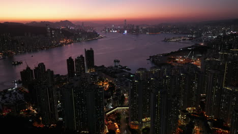 beautiful colored sky after sunset over the illuminated city of hong kong and victoria harbour