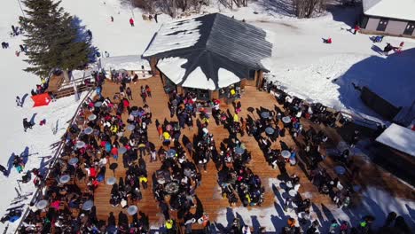 aerial top down shot of people resting at ski resort bar after skiing on vermio mountain in greece during sunny day