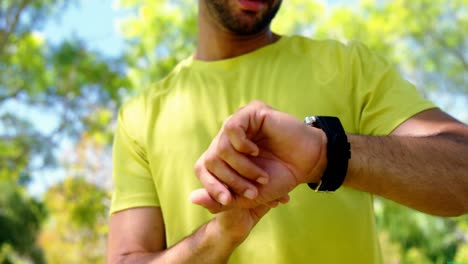 Man-using-smartwatch-in-park-4k