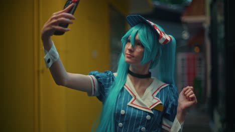 teenager in hatsune miku cosplay taking a selfie