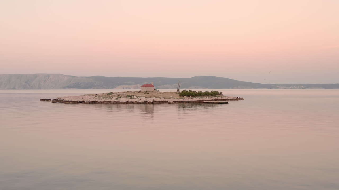 Sunrise view of a small inhabited island in the middle of the sea