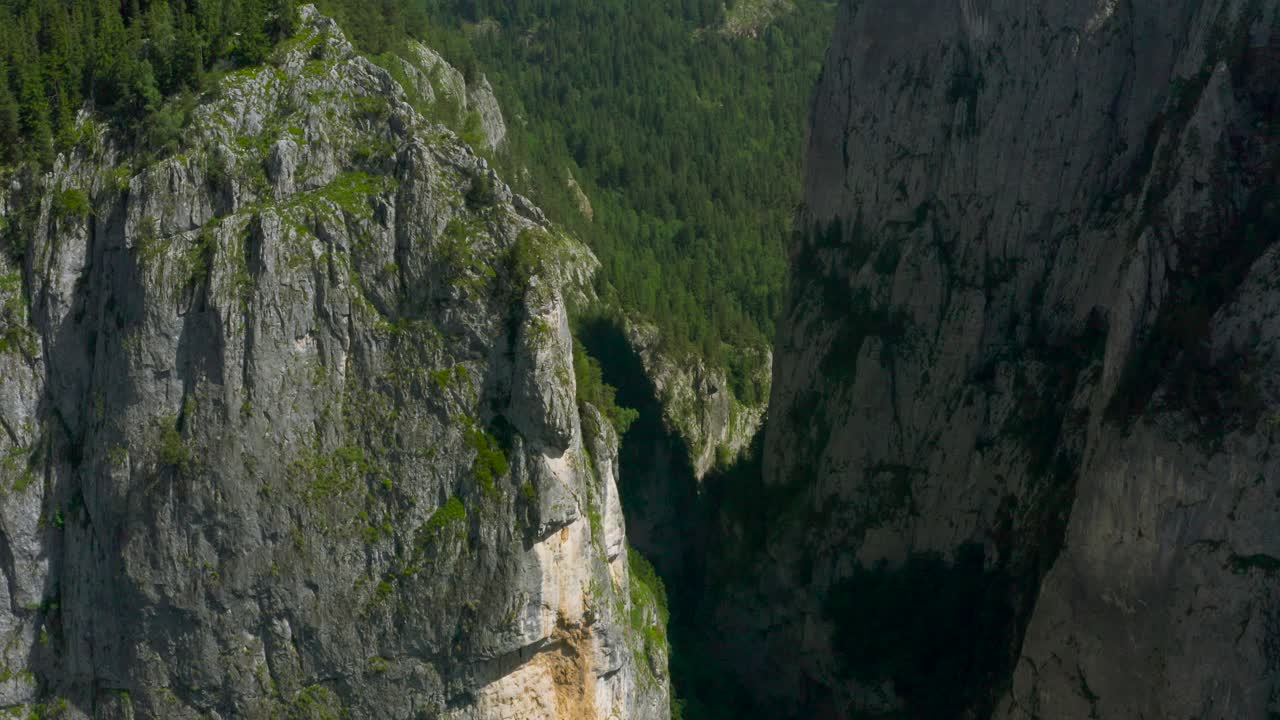 Aerial shot overlooking vertical rock walls in Bicaz Gorge, Romania