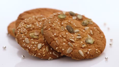 eat oatmeal cookies. stack of whole meal cookies on white background. wheat fall on dietary cookies