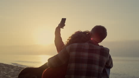 lovely couple taking selfie photo on beach. loving woman and man dating at ocean