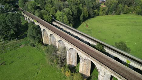 Fly over Chirk railway Viaduct, revealing Aqueduct and valley - aerial drone anti-clockwise rotate - Welsh, English border, Sept 23