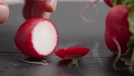 Chef-cuts-radish-on-a-slate-board-to-prepare-cebiche