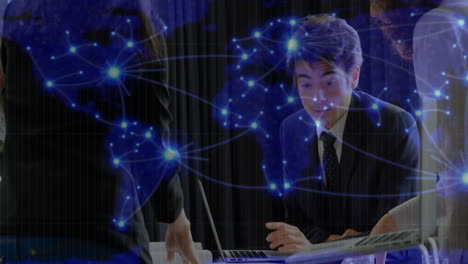 animation of glowing global network over caucasian businessman talking at office meeting