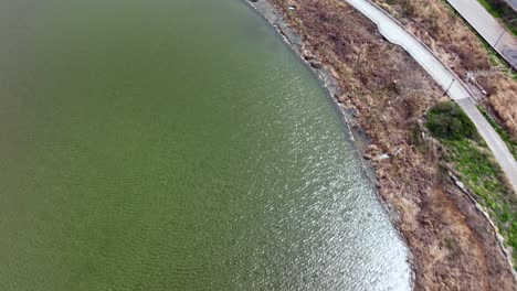 A-top-down-view-over-a-lake-in-a-park-on-a-sunny-day