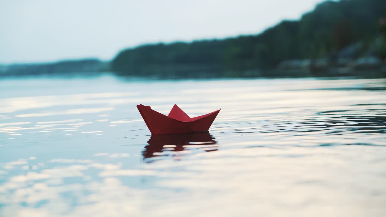 Paper boat floating on water