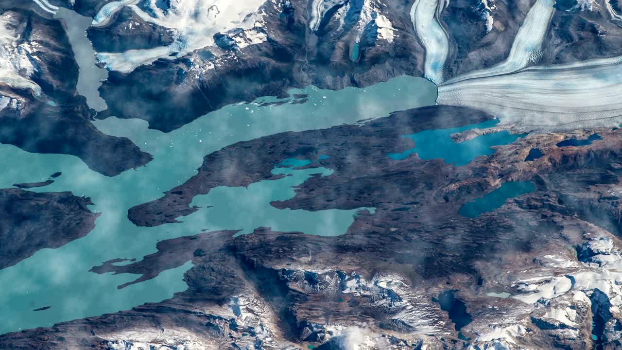 Flying over the earth on the ISS. Flying over the snow-capped mountains, aerial view from space.