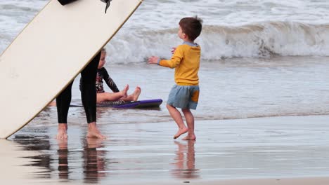 a boy enjoys the beach and waves